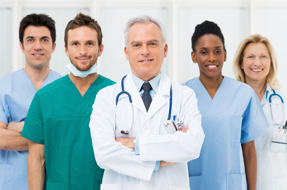 A group of doctors and nurses standing in front of each other.