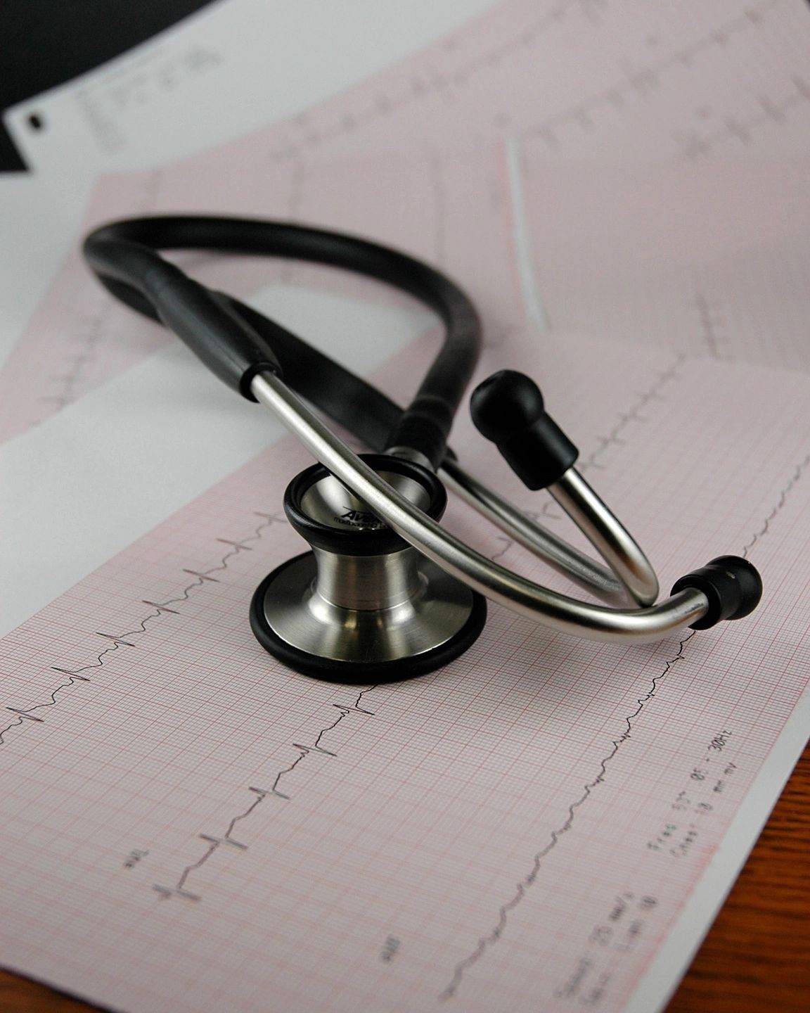 A stethoscope sitting on top of an ecg chart.