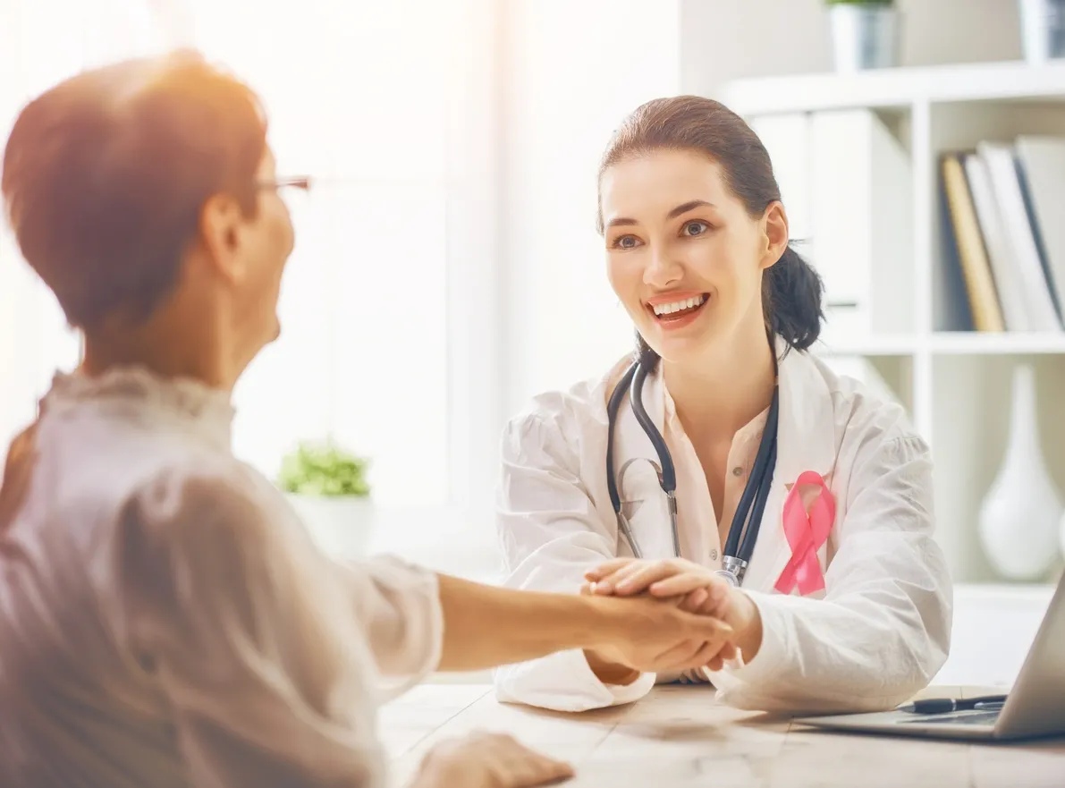 A woman shaking hands with another person.